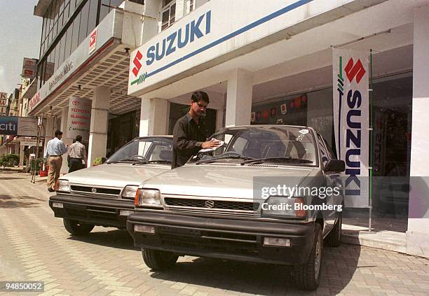Worker at Pakistan Suzuki Motors cleans a Suzuki Mehran in Islamabad, Pakistan on April 9, 2004. Shares of Pak Suzuki Motor Co. And Indus Motor Co.,...