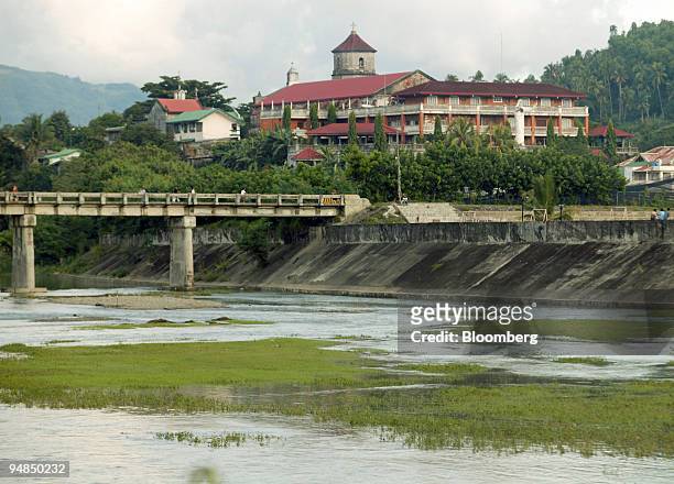 The Boac River passes through Boac on the Philippine island of Marinduque October 9, 2005. Once a heavily polluted river due to copper tailings...