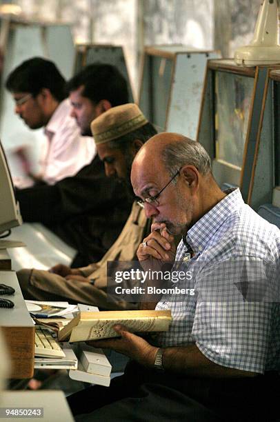 Stockbrokers work inside the trading hall of the Karachi Stock Exchange in Karachi, Pakistan, on Monday, Sept. 8, 2008. Pakistan's Asif Ali Zardari...