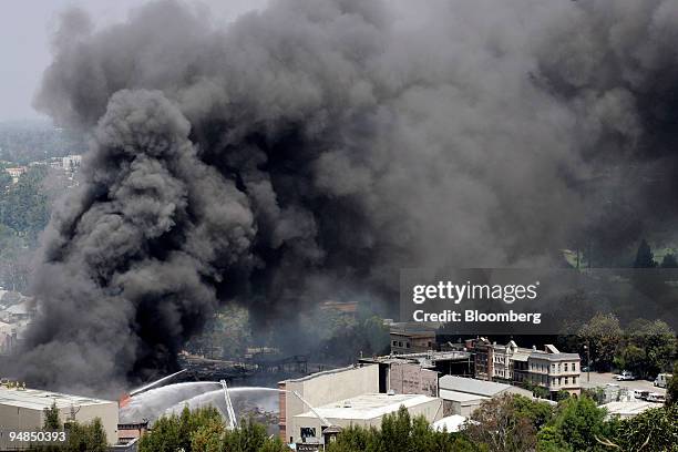 Firefighters battle a fire at Universal Studios in Universal City, California, U.S., on Sunday, June 1, 2008. King Kong, the giant ape from Skull...