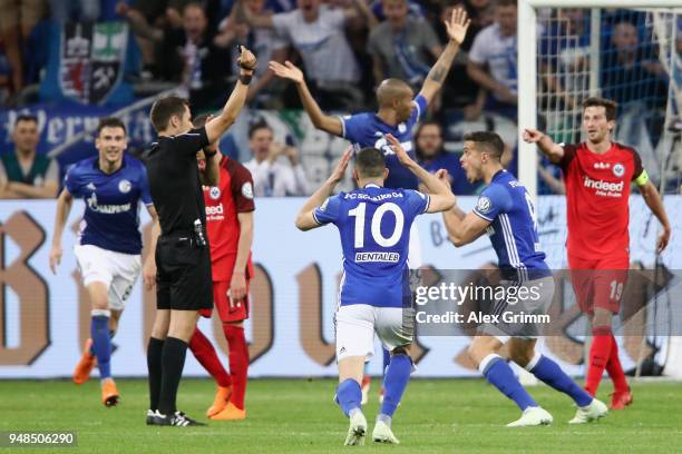 Players discuss with referee Robert Hartmann after Franco di Santo of Schalke scored a disallowed goal during the DFB Cup Semi Final match between FC...