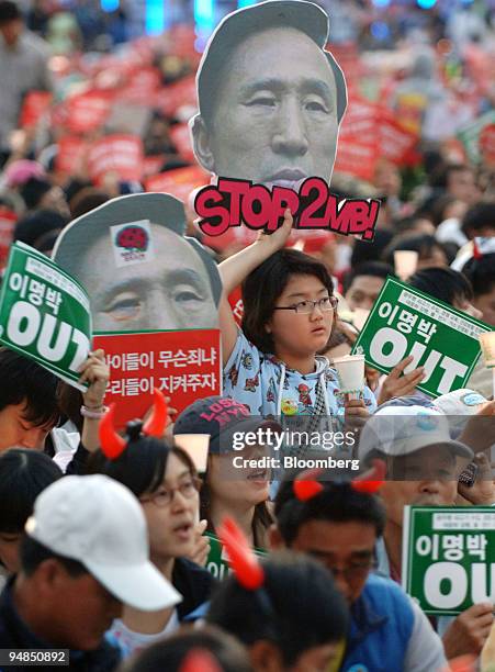 People participate in a candlelight vigil to protest against U.S. Beef imports in Seoul, South Korea, on Saturday, May 31, 2008. South Korean...