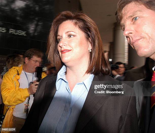 Lea Fastow, former Enron Corp. Assistant treasurer, leaves the federal courthouse in Houston, Texas April 7, 2004. Seen at right is Paul Nuget, a...