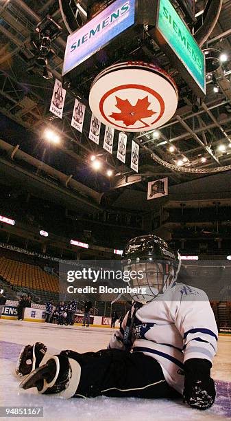 Three-year-old Joshua Maida, for whom skating is still a learning process, sits under the Air Canada Centre's scoreboard with the "Roundel" promoting...