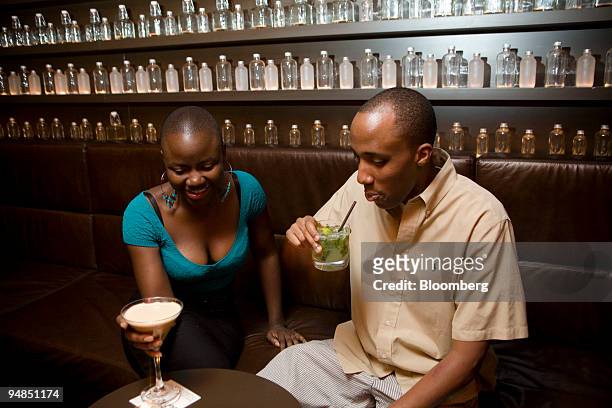 Vimbai Matsikidze, left, and Chris Michev drink an espresso martini and a mojito in the Delicatessen basement bar in New York, U.S., on Thursday,...