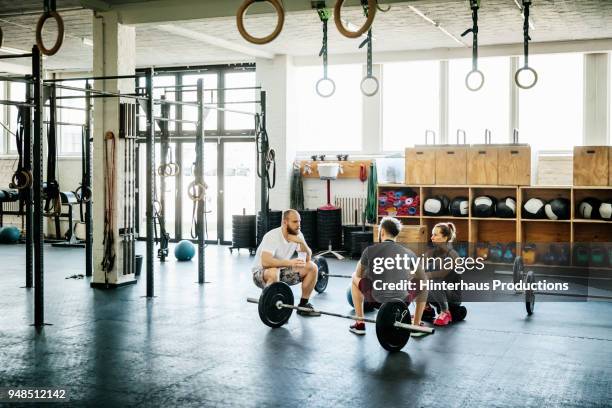 friends taking break from weight lifting at gym - 3 gym stock pictures, royalty-free photos & images