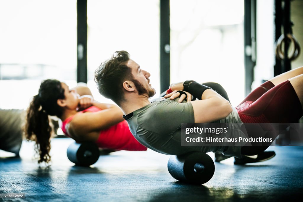 Gym Goers Performing Floor Exercises Together