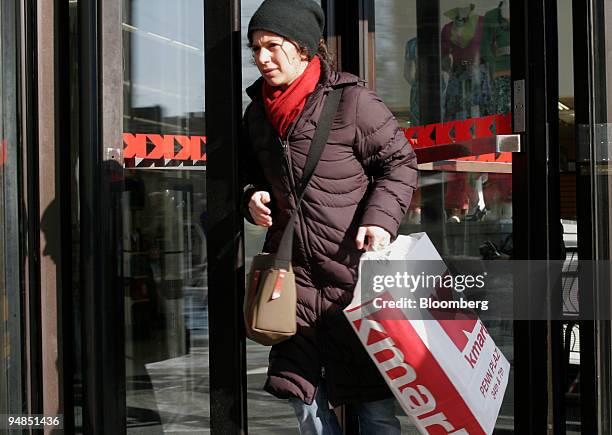 Shopper exits the Astor Place Kmart store in New York on Tuesday, February 14, 2006. Retailers rang up their biggest sales gains since May 2004 last...