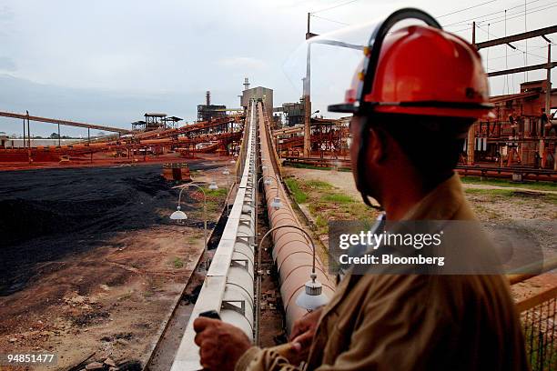 An employee stands at the Alunorte aluminum refinery, owned by Cia Vale do Rio Doce, in Barcarena, Brazil, on Thursday, Aug. 14, 2008. Vale, the...