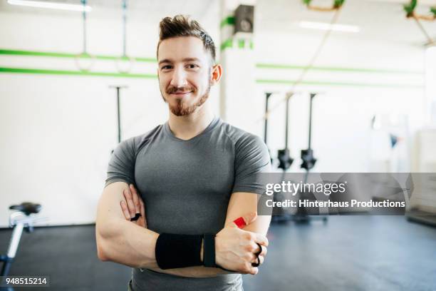 portrait of fitness trainer at gym - fitness trainer stock-fotos und bilder