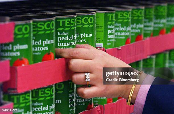 Tesco employee stocks a shelves at the Tesco store in west London, Monday January 17, 2005.The U.K.'s biggest supermarket operator, said sales rose...