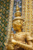 Golden statue at the Wat Phra Kaew Palace, also known as the Emerald Buddha Temple. Bangkok, Thailand.