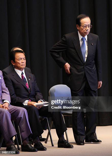 Yasuo Fukuda, Japan's prime minister and president of the Liberal Democratic Party , right, stands next to Taro Aso, secretary general, during the...