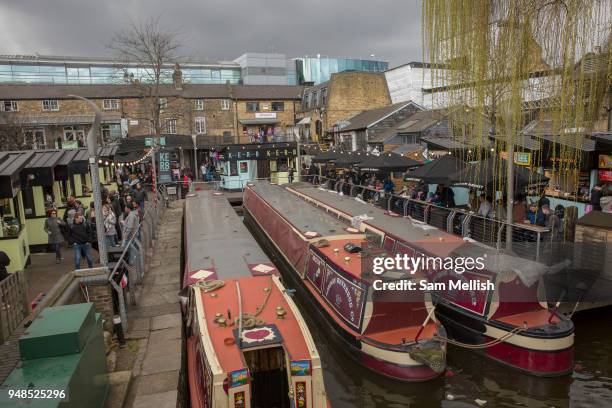 Three narrowboats at Camden Lock in Camden Town on the 27th March 2018 in North London, United Kingdom.