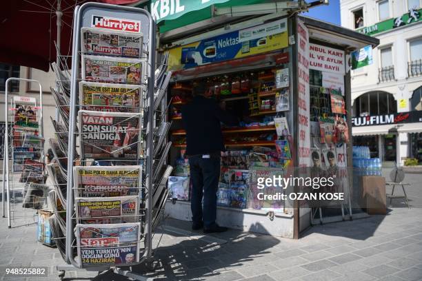 Man buys a newspaper at a newsstand in Istanbul, Turkey, on April 19, 2018. - Turkish President Recep Tayyip Erdogan on April 18, 2018 called snap...