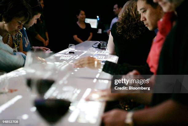 Patrons use the electronic wine menu at Clo located in the Time Warner Center in New York, U.S., on Friday, Aug. 29, 2008. A few sips of Vega Sicilia...