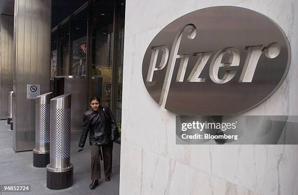 Woman leaves Pfizer world headquarters in New York on November 30, 2004. Pfizer Inc., the maker of the world's biggest-selling drug, may be the first...