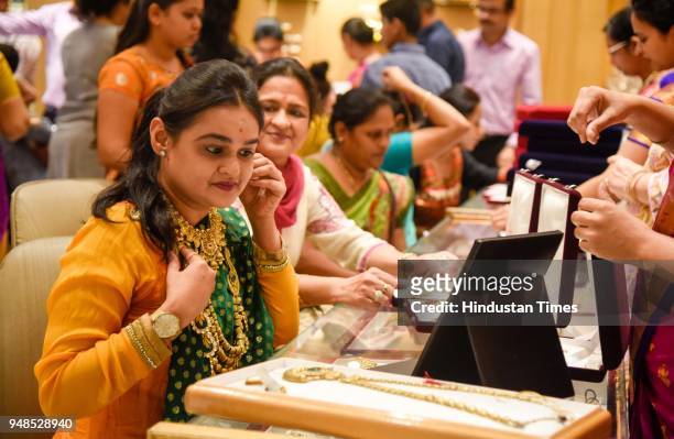 People buy gold ornaments on the occasion of Akshay Tritiya in a Jewellery Shop on Laxmi road, on April 18, 2018 in Pune, India. Akshaya Tritiya,...