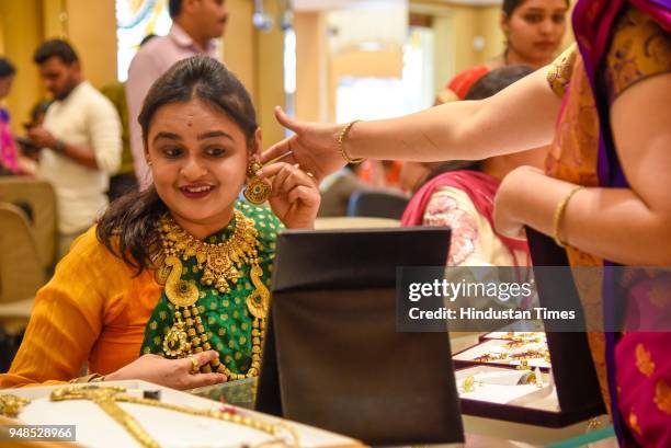 People buy gold ornaments on the occasion of Akshay Tritiya in a Jewellery Shop on Laxmi road, on April 18, 2018 in Pune, India. Akshaya Tritiya,...