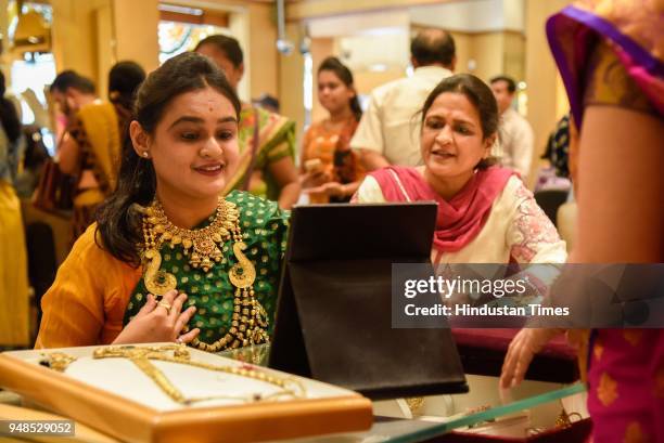 People buy gold ornaments on the occasion of Akshay Tritiya in a Jewellery Shop on Laxmi road, on April 18, 2018 in Pune, India. Akshaya Tritiya,...