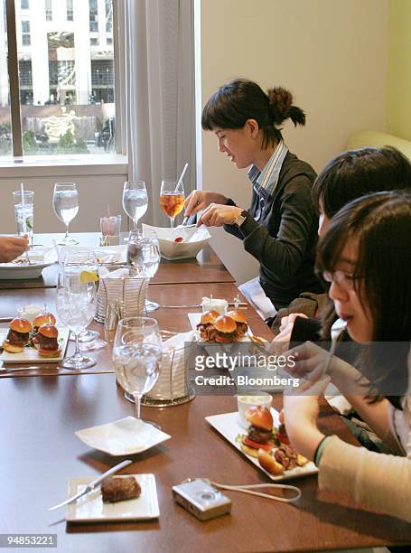 Nam Hee Kim, front to back, Joo Hee Kim, and Grace Lee Min eat lunch at the Saks Fifth Avenue restaurant HTwo, located on the second floor that...