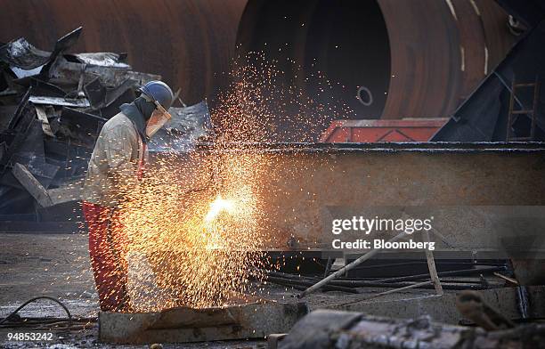 Shipyard worker cuts up pieces of the MSC Napoli cargo ship, as it lies in a dry dock at the Harland and Wolff ship builders in Belfast, Northern...