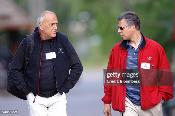 Convera Corp. Chief Technology Officer Dr. Claude Vogel, left, and Convera Corp. President and CEO Pat Condo, right, walk in the early morning at the...