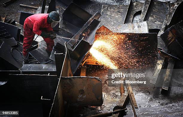 Shipyard worker cuts up pieces of the MSC Napoli cargo ship, as it lies in a dry dock at the Harland and Wolff ship builders in Belfast, Northern...