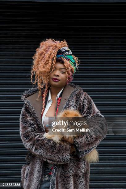 Young woman with her pet Pomeranian dog, Brixton, south London, 11th April 2018.