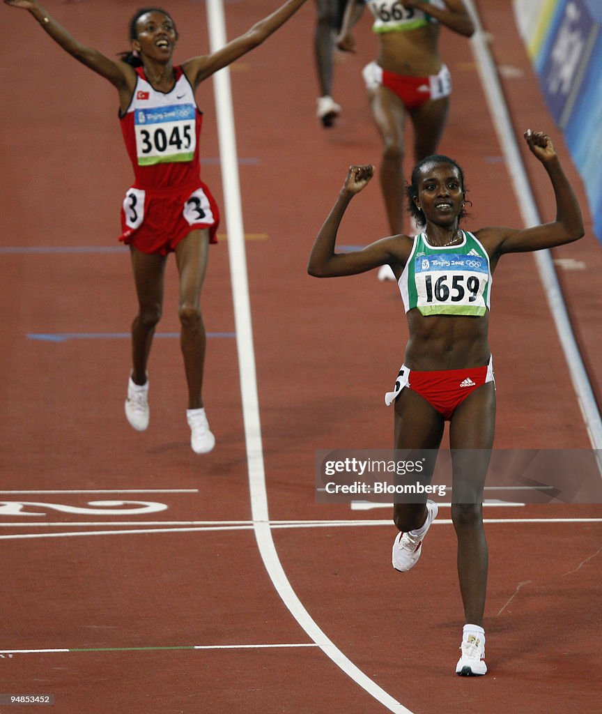 Tirunesh Dibaba of Ethiopia, cheers as she crosses the finis