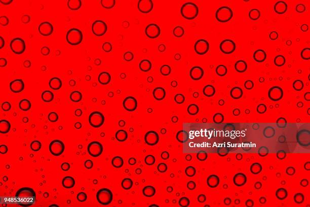 drops of water on a color background. red tone - indo china border stock pictures, royalty-free photos & images