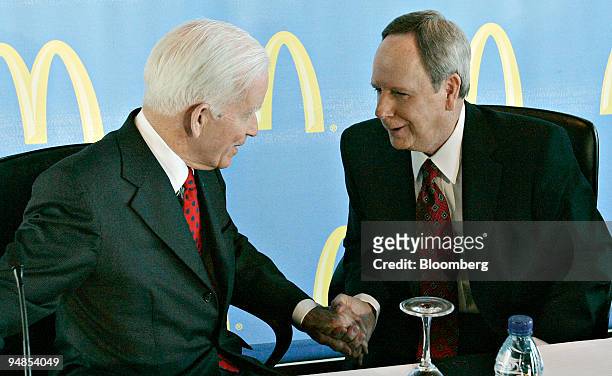 Andrew McKenna, chairman of the McDonald's Corp. Board, left, shakes hands with James Skinner, chief executive officer of McDonald's Corp., at the...