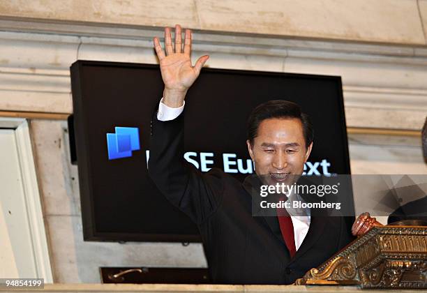 Lee Myung Bak, South Korea's president, waves after ringing the opening bell at the New York Stock Exchange in New York, U.S., on Wednesday, April...