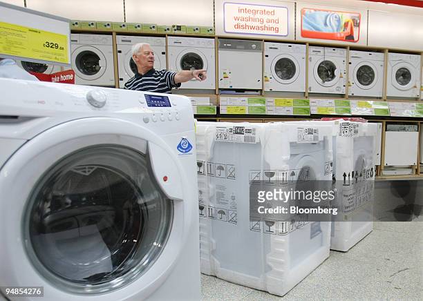 Customer looks at washing machines and tumble dryers at a Currys shop in London, U.K., on Wednesday, May 21, 2008. U.K. Consumer confidence dropped...