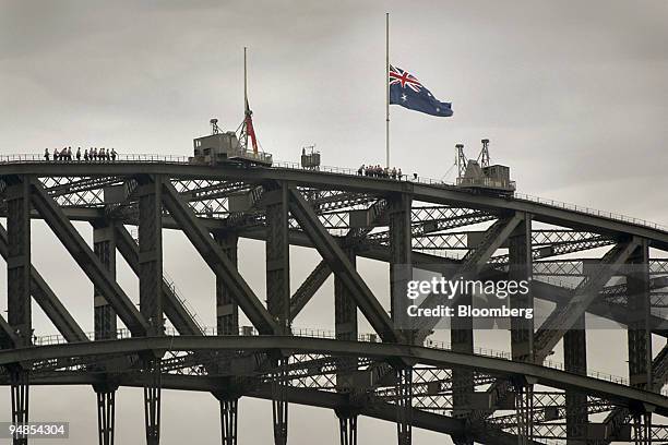 In the aftermath of the London bombings, flags fly at half mast atop the Sydney Harbour Bridge in Sydney, Australia Friday, July 8, 2005. Australia...