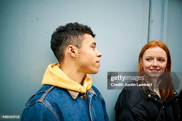 teenage couple having a moment together while hanging out with friends - young love stock-fotos und bilder