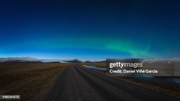 road and aurora borealis, iceland - olafsvik stock pictures, royalty-free photos & images