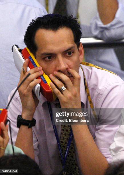 Trader talks on the telephone while working on the floor of the Bolsa de Mercadorias e Futuros, or Brazilian Mercantile and Futures Exchange , in Sao...