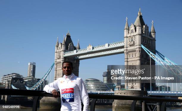 Ethiopia's Kenenisa Bekele poses for a picture in front of Tower Bridge during the media day at the Tower Hotel, London.