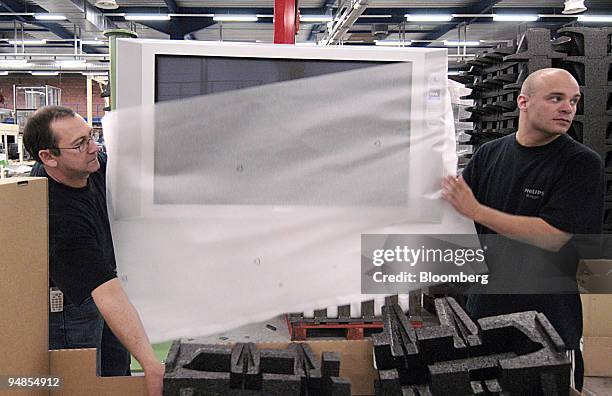 Assembly workers pack a new Plasma 42inch flat screen TV at the Philips production plant in Bruge, Belgium, Wednesday, March 31, 2004.Europe's...