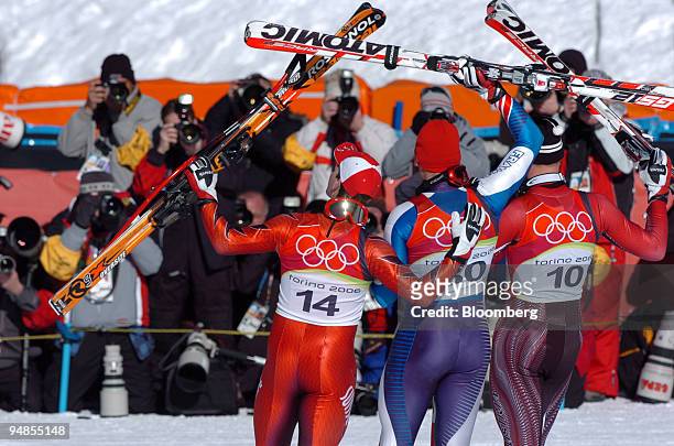 Olympic men's downhill gold medalist Antoine Deneriaz of France, center, silver medalist Michael Walchhofer of Austria, right and bronze medal winner...
