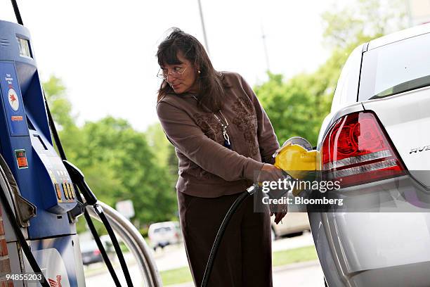 Karen Sigler fills up a United States Post Office owned Dodge Avenger with E85, a mixture of 85 percent ethanol and gasoline, at a Mobil station in...