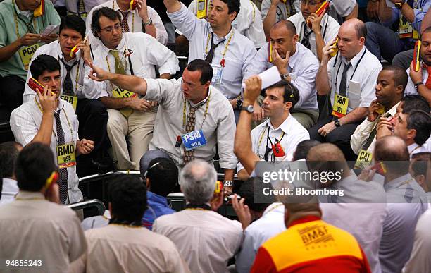 Traders work at the Bolsa de Mercadorias e Futuros, or Brazilian Mercantile and Futures Exchange , in Sao Paulo, Brazil, on Monday, Nov. 10, 2008....