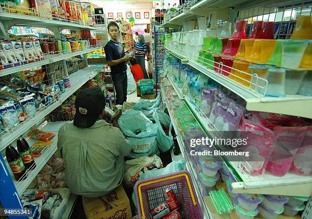 Staff clean and restock the shelves at a supermarket after it reopened in Banda Aceh, Indonesia on Sunday, January 9, 2005. Two weeks after the...