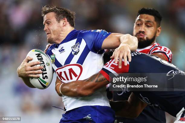 Brett Morris of the Bulldogs is tackled by Roosters defence during the round seven NRL match between the Canterbury Bulldogs and the Sydney Roosters...