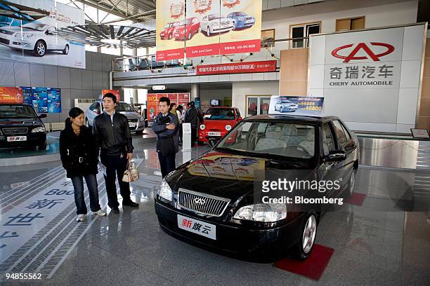 People examine a Chery Automobile Co. Ltd. Cowin at a dealership in Beijing, China, on Sunday, Nov. 9, 2008. China's auto exports may grow 20 percent...