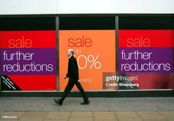 Man passes signage outside sale signs on a Marks & Spencer store on Oxford Street, central London, Friday January 7, 2005. Marks & Spencer Group Plc,...