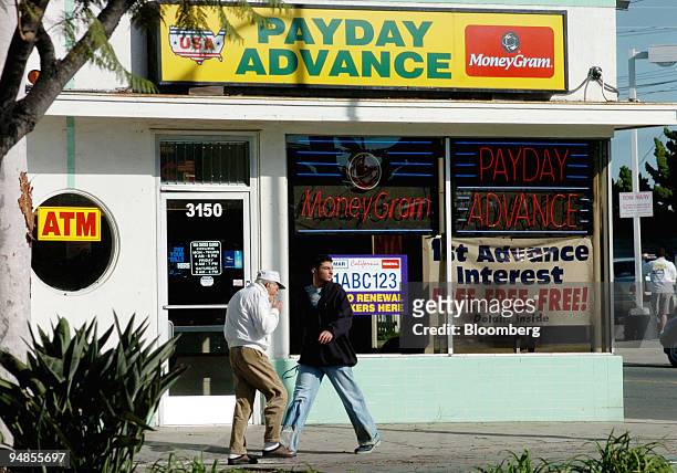 Pedestrians walk past a Payday Advance shop on El Cajon Blvd. In San Diego, California on Tuesday, November 23, 2004. Since emerging from rural...