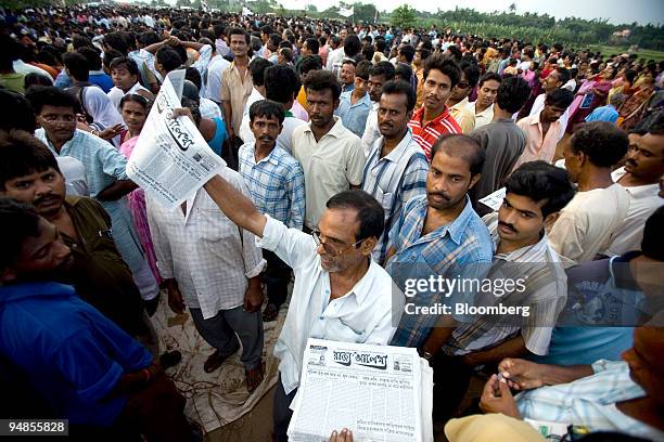 Protestor sells a newspaper in front of the unfinished Tata Nano plant during a demonstration in Singur, India, on Tuesday, Aug. 26, 2008. West...