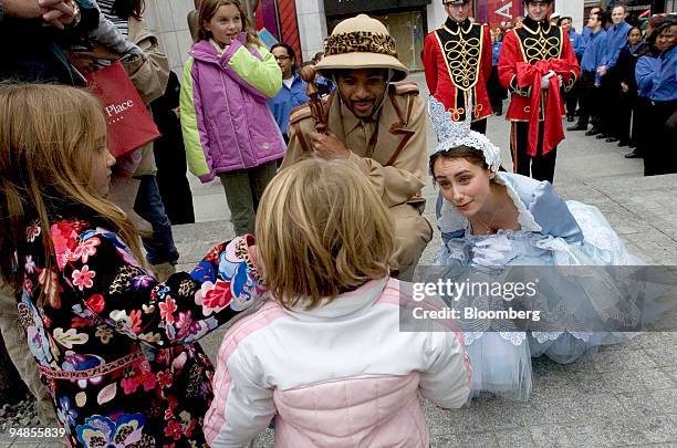 Stacie Levy, dressed as a Fairy Princess, right, and Alexander Elisa as Safari Sam, greet Rubie Deluca in pink jacket, and her sister Isabelle...